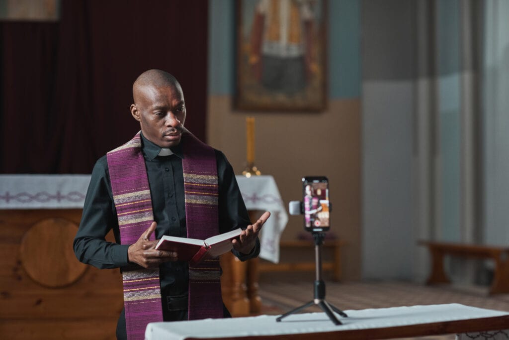 A priest live streaming a funeral himself