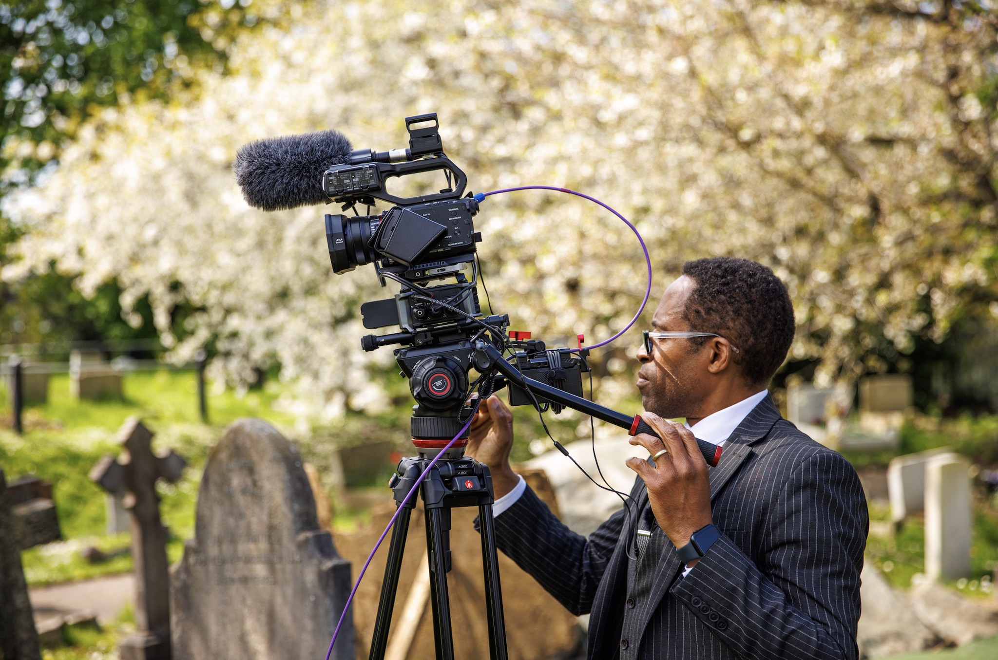 Videoing a funeral service in front of a beautiful tree in England